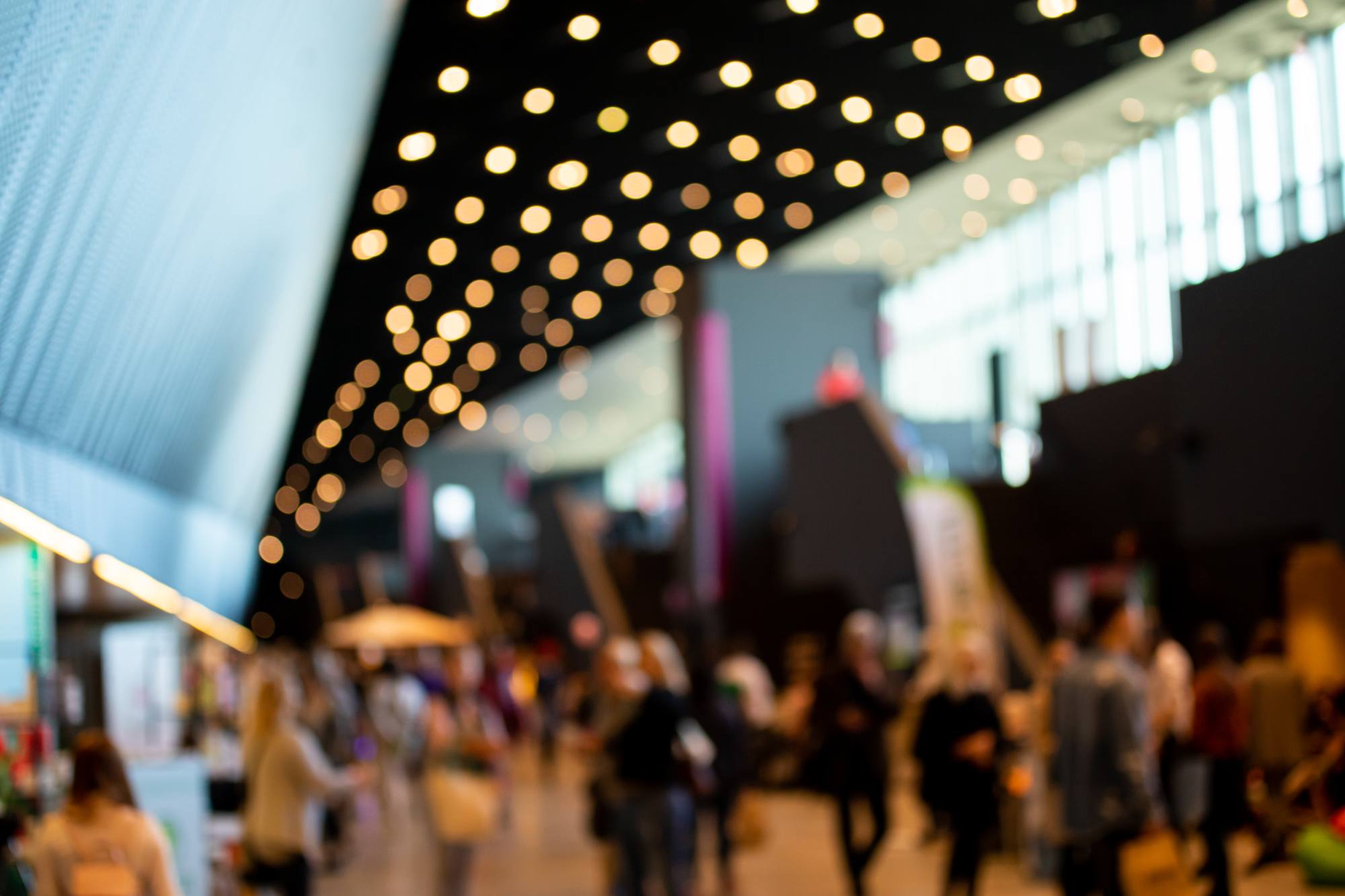 blurred crowd of people in modern interior during